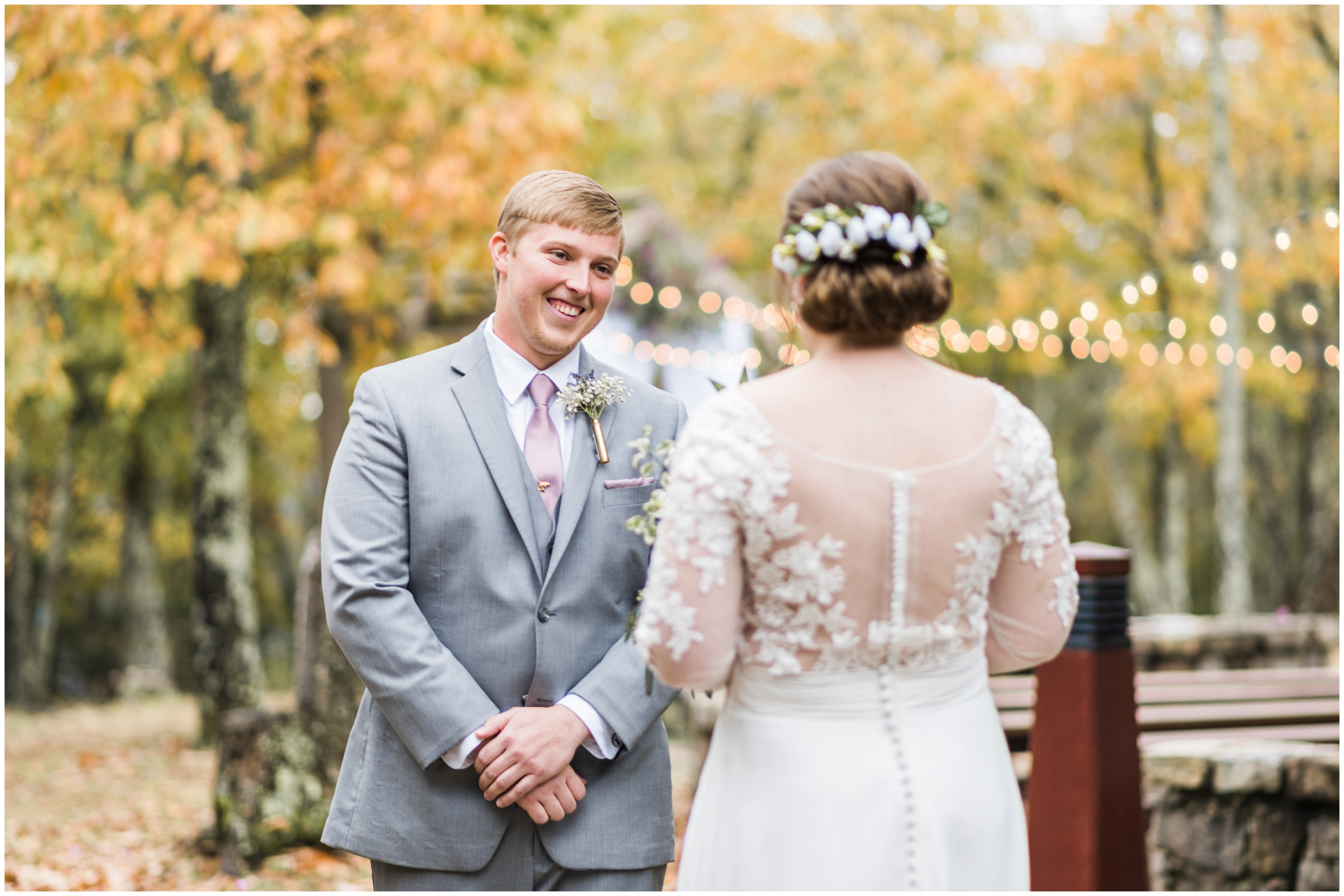 Monte Sano Lodge Fall Wedding Photography First Look Groom in Grey Suit String Lights on Background - Huntsville Wedding Photographer