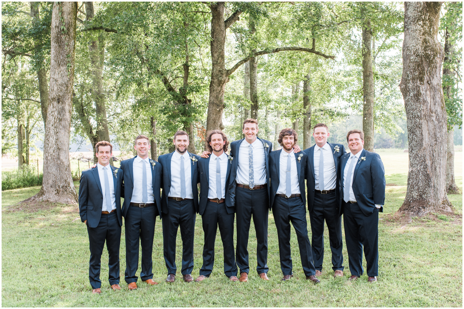 Groomsmen photo in navy suits and slate blue ties at Harvest Hollow Venue and Farm 
