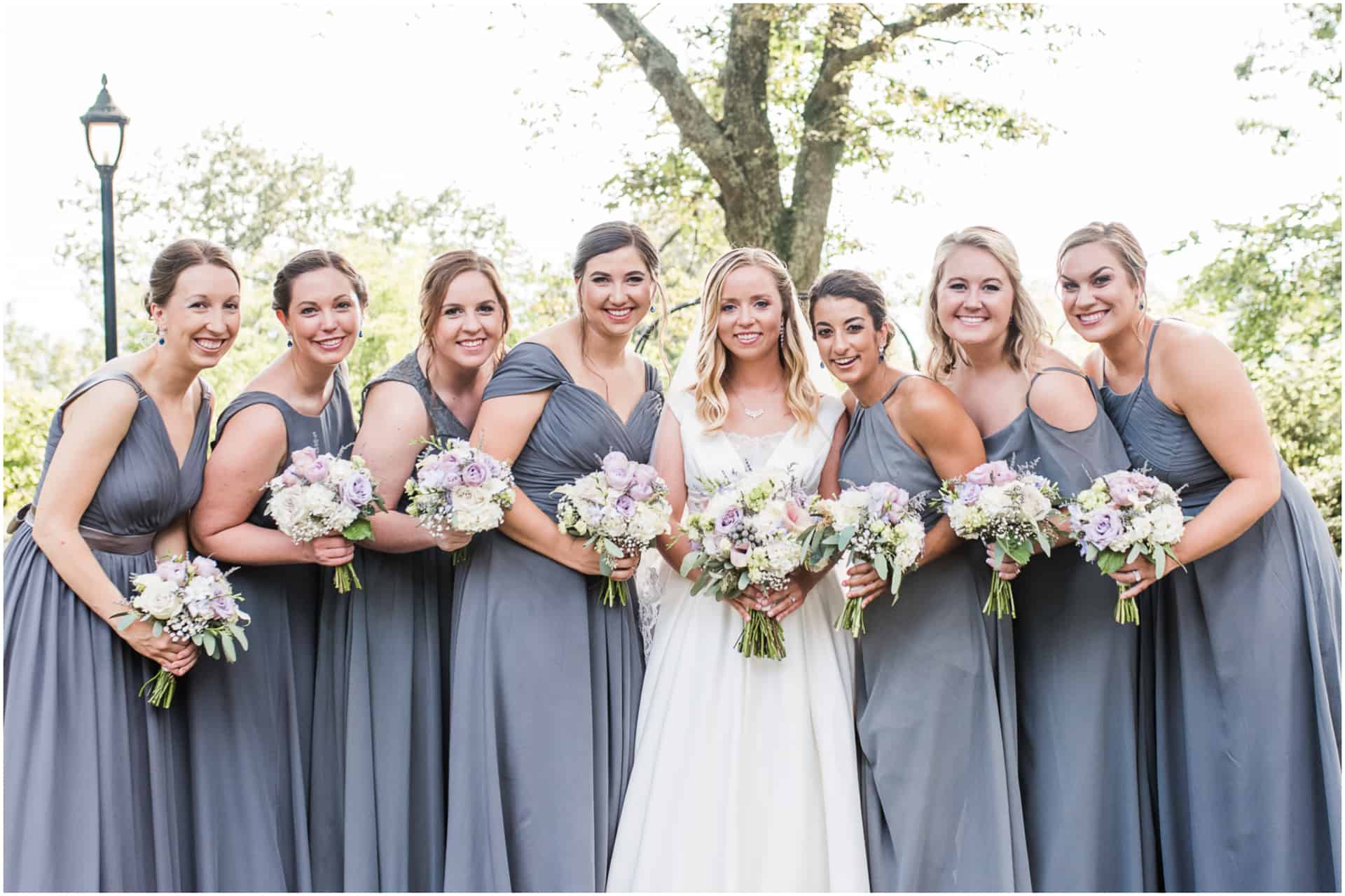 bride and bridesmaids in gray dresses at burritt mansion Huntsville Alabama
