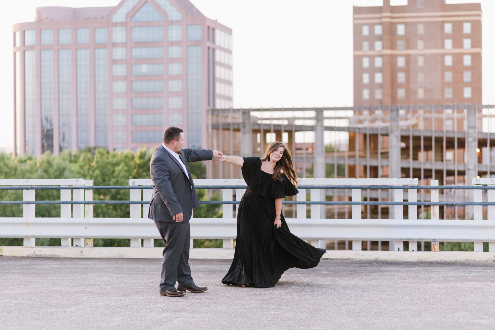 Couple dancing on a rooftop parking garage engagement session