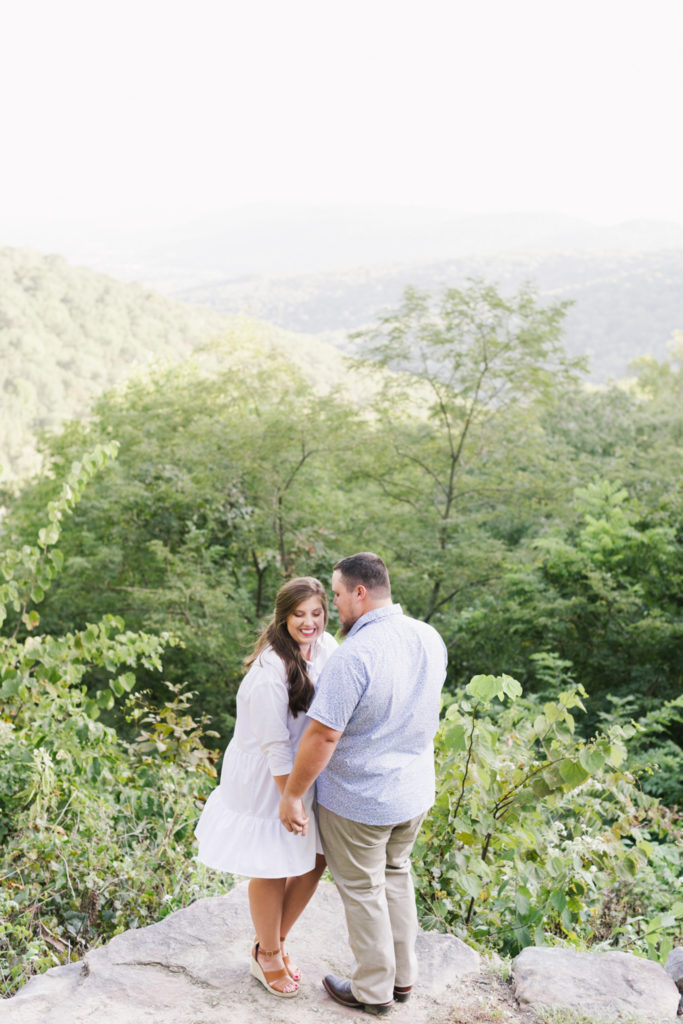 A couple takes engagement photos in the mountains