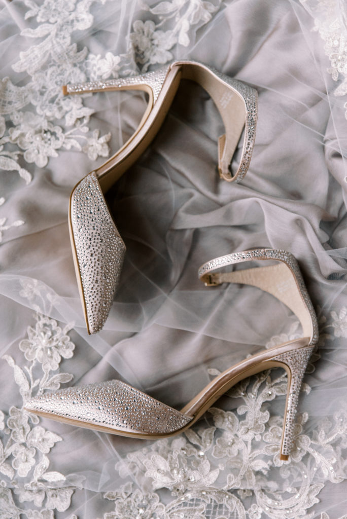 Wedding detail shot of the bride's shoes resting on a veil