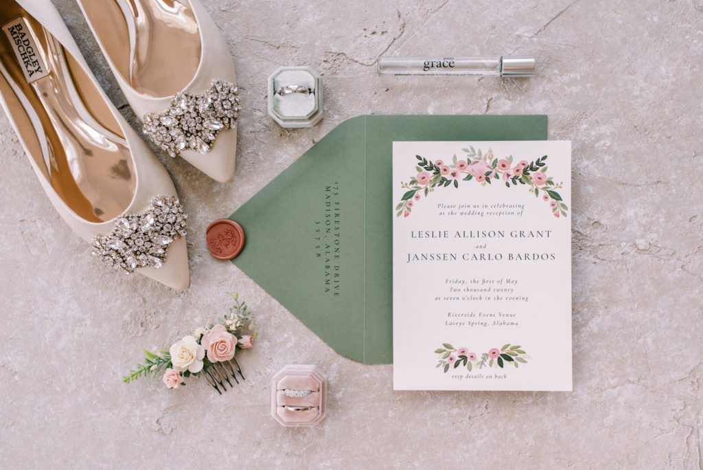 Wedding detail shot with botanical invitations, flowers and antique ring boxes