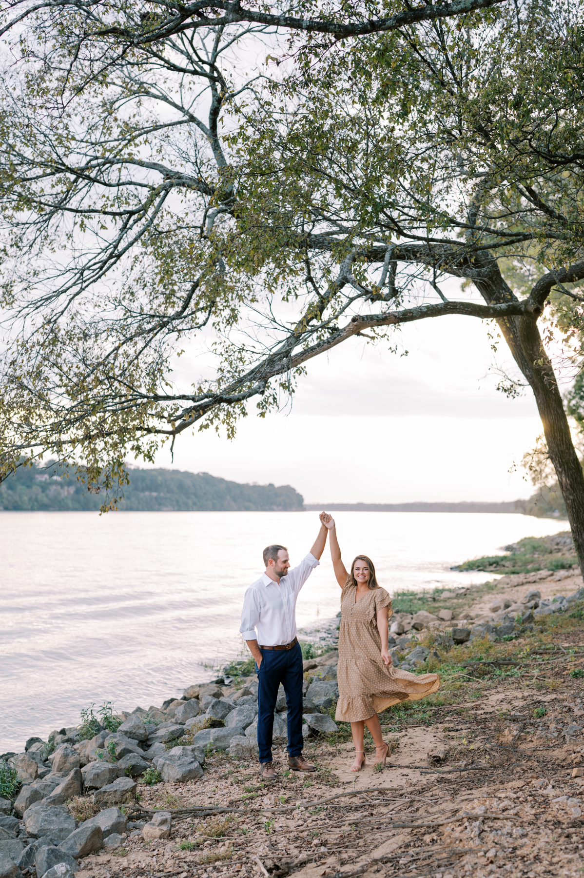 Engaged couple taking photos on the river at McFarland park in Florence Alabama
