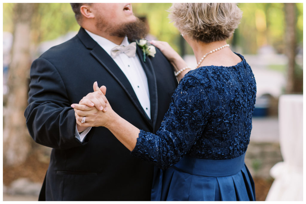 holding mother of the grooms hand